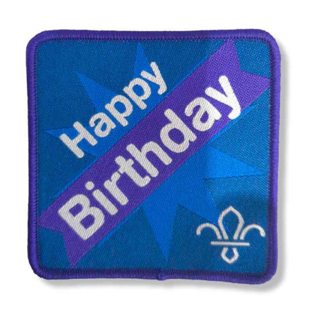 Insigne humouristique Happy birthday avec emblème "Fleur de Lys"